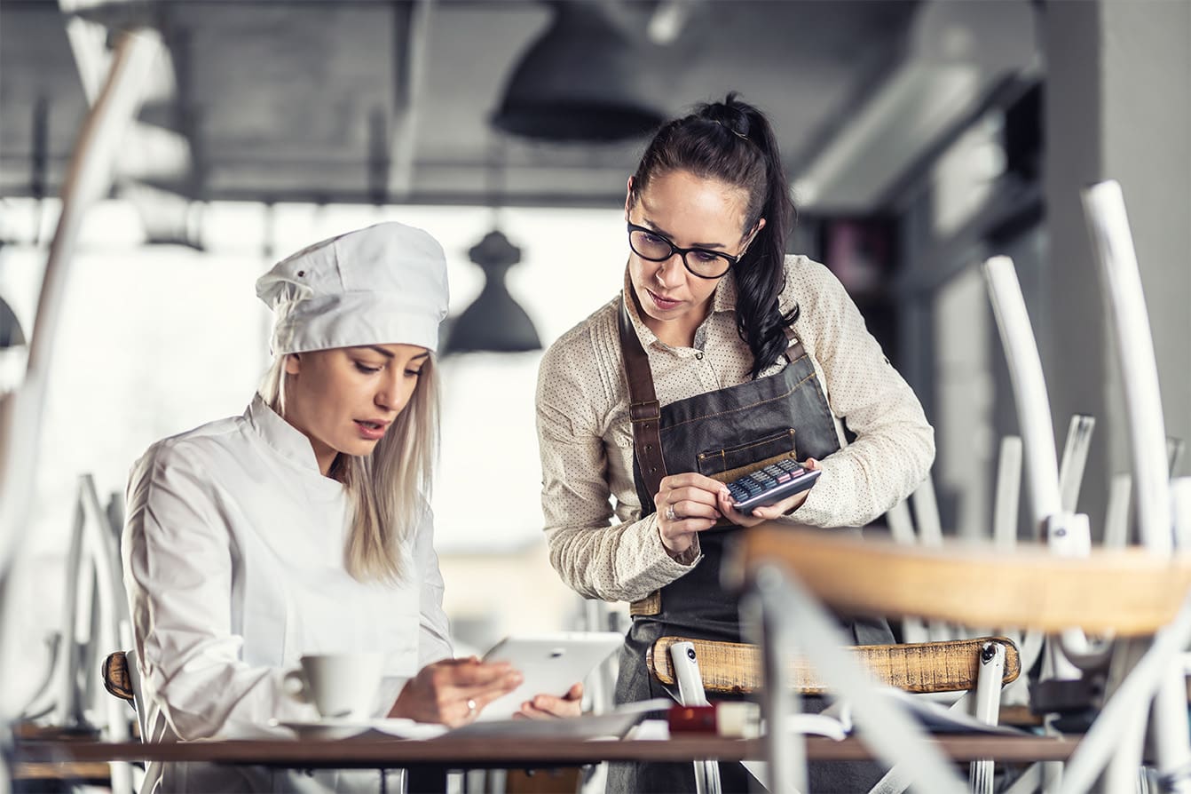 A chef calculating food cost before restaurant opens.