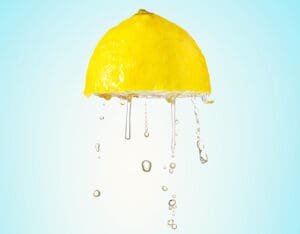 lemon juice getting squeezed out of a lemon
