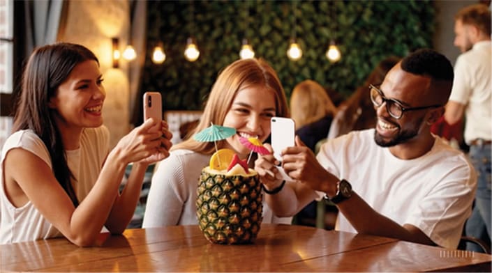 taking-pictures-of-their-drink-in-a-pineapple-cup-3-table