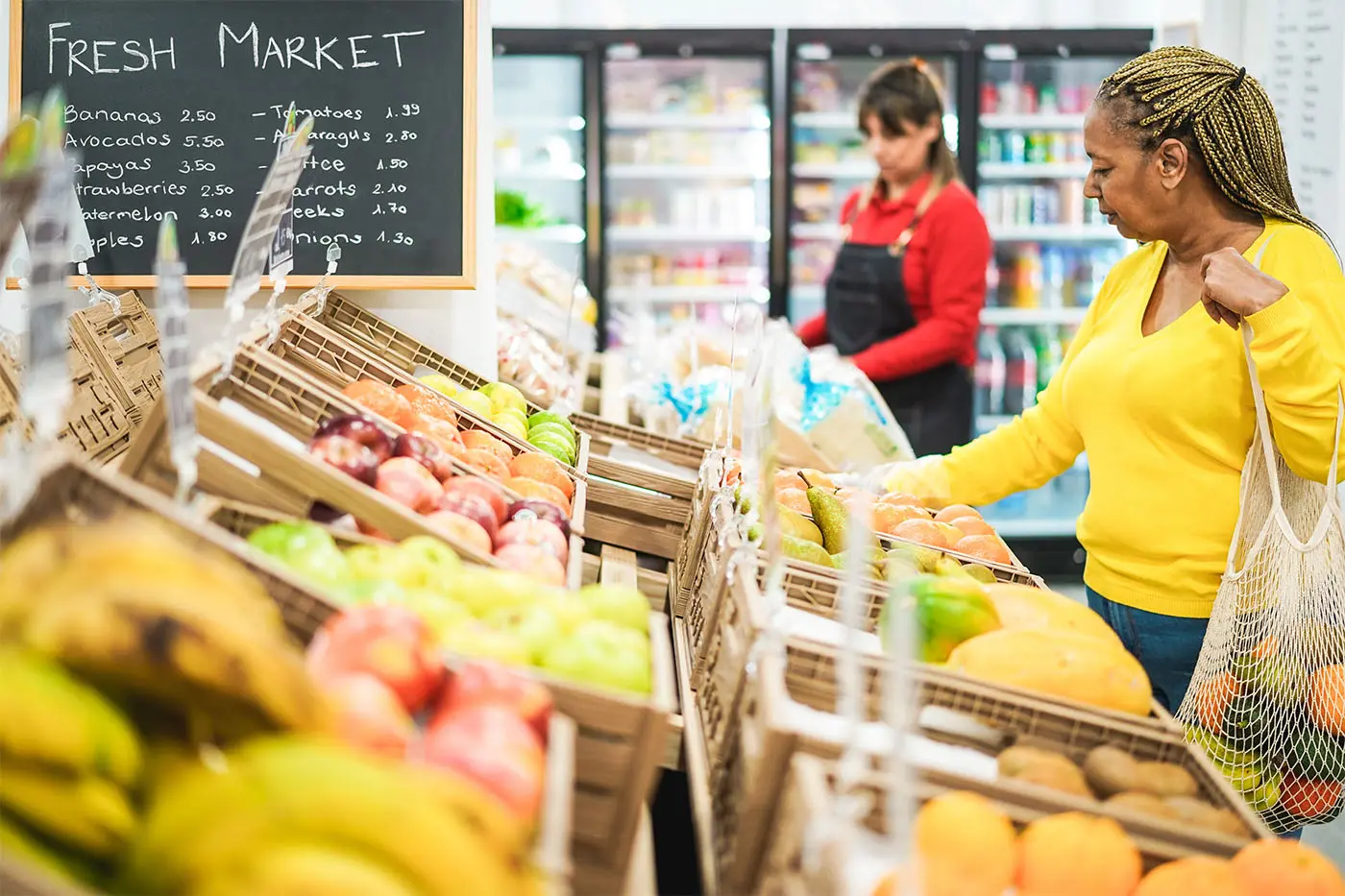 Customer buying produce in grocery store