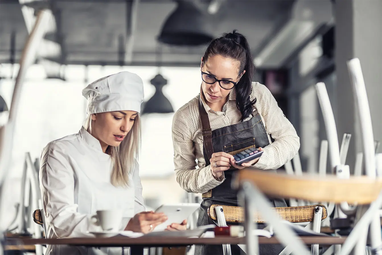 A chef calculating food cost before restaurant opens.