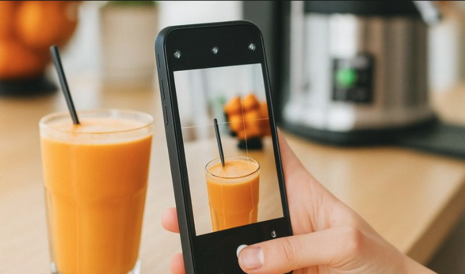 Taking a picture of a juice bought at a juice bar to share on social media